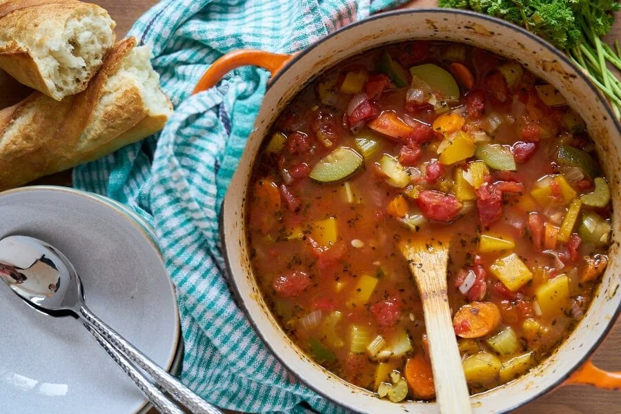 Bowl of Fall Harvest Vegetable Soup with fresh vegetables and herbs