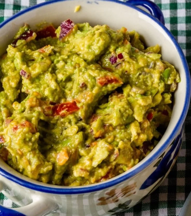 Delicious grilled guacamole served with tortilla chips and fresh herbs