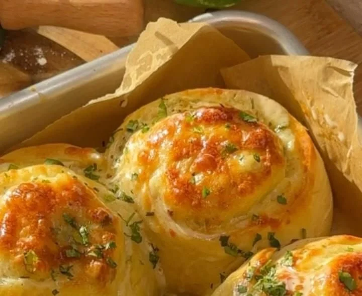 Delicious Cheese Garlic Rolls topped with herbs and melted cheese.
