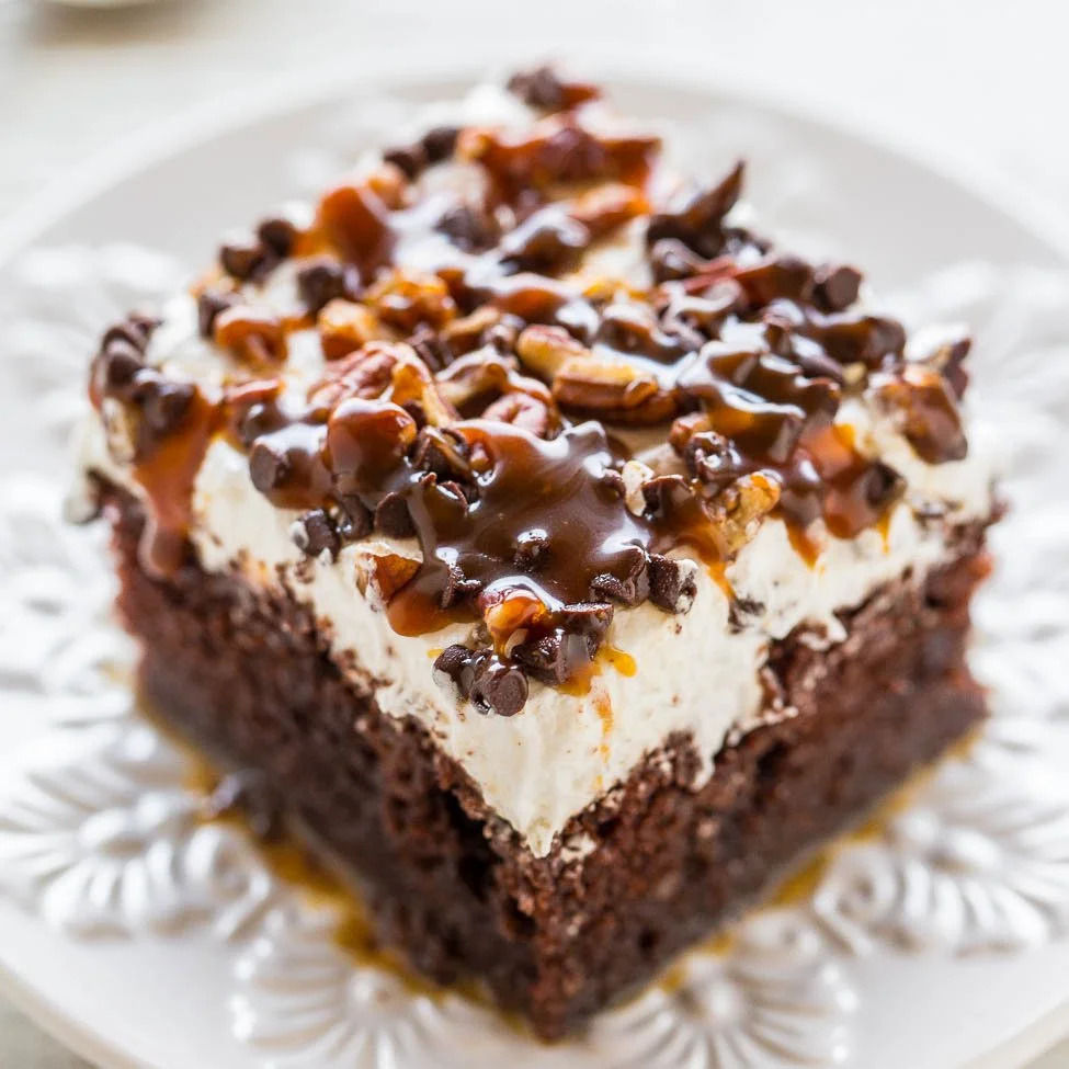 Delicious Chocolate Turtle Cake with caramel and pecans on a decorative plate.