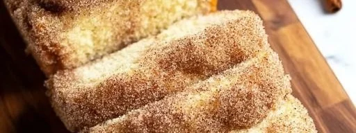 Sliced Cinnamon Sugar Donut Bread on a wooden board