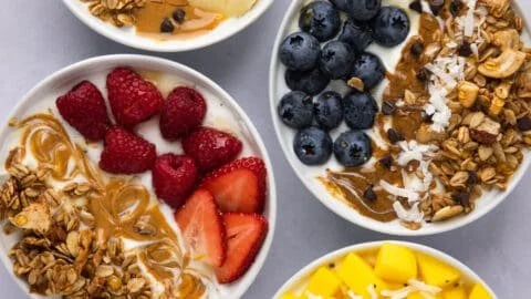 Delicious yogurt granola bowls served in colorful dishes with fresh fruits