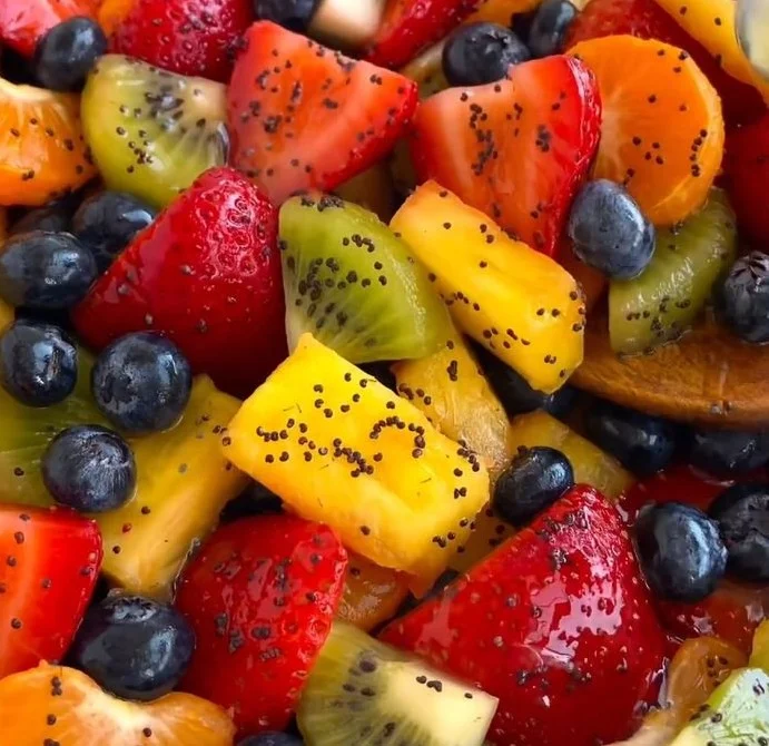 A vibrant Honey Lime fruit salad featuring assorted fresh fruits in a bowl