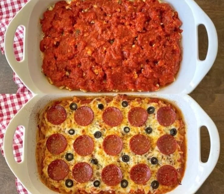 Keto Cauliflower Pizza Casserole topped with cheese and herbs