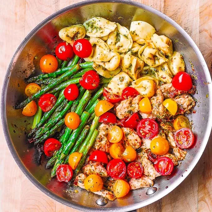Pesto Chicken Tortellini garnished with fresh vegetables