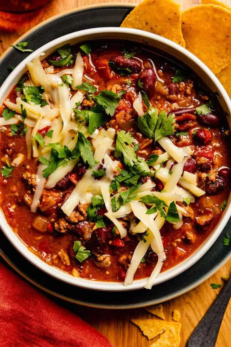Bowl of easy homemade chili with toppings like cheese and cilantro