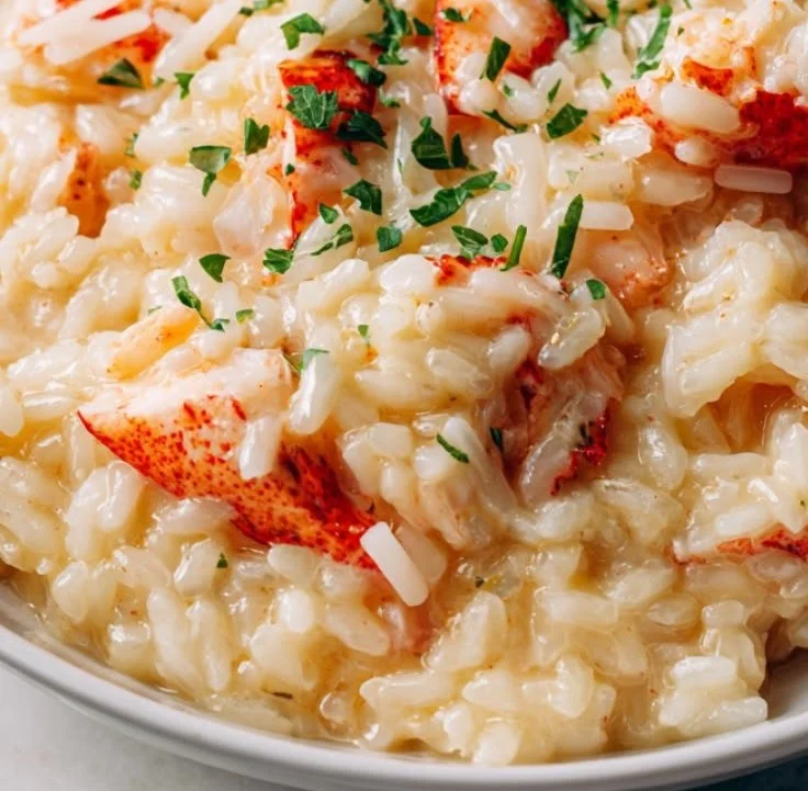 Delicious Lobster Risotto topped with fresh herbs and seafood, served in a bowl