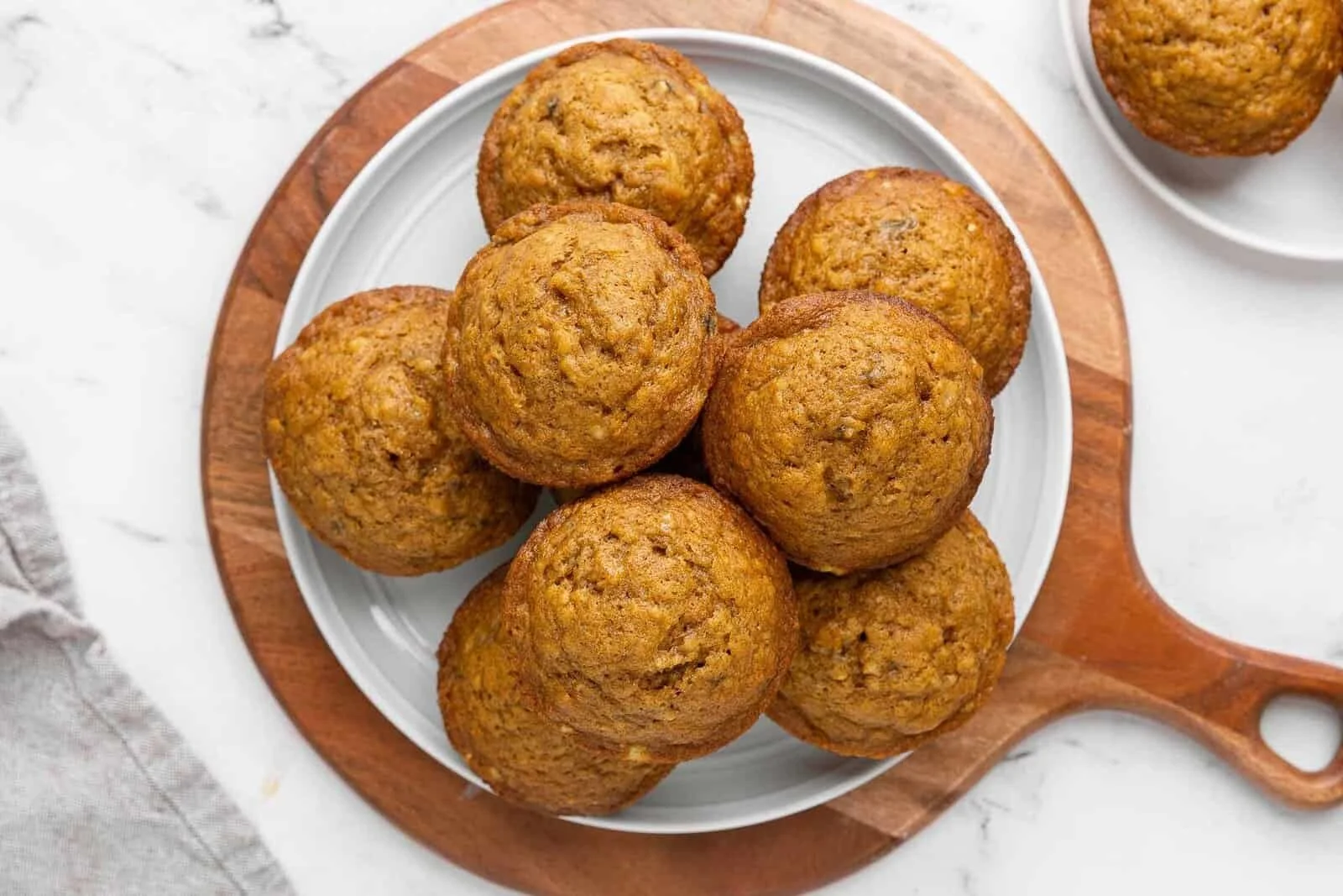 Freshly baked Pumpkin Banana Muffins on a wooden table