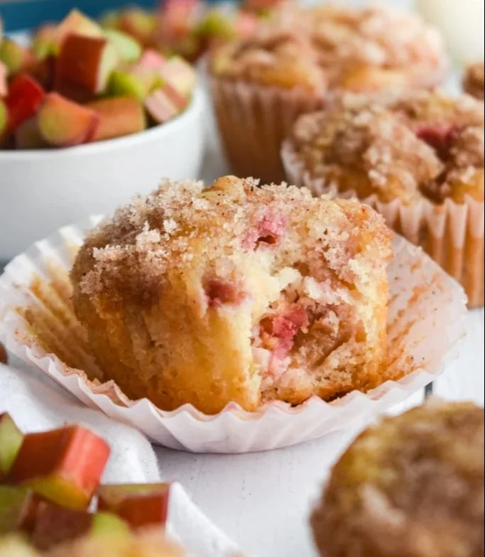 Freshly baked rhubarb muffins on a wooden table
