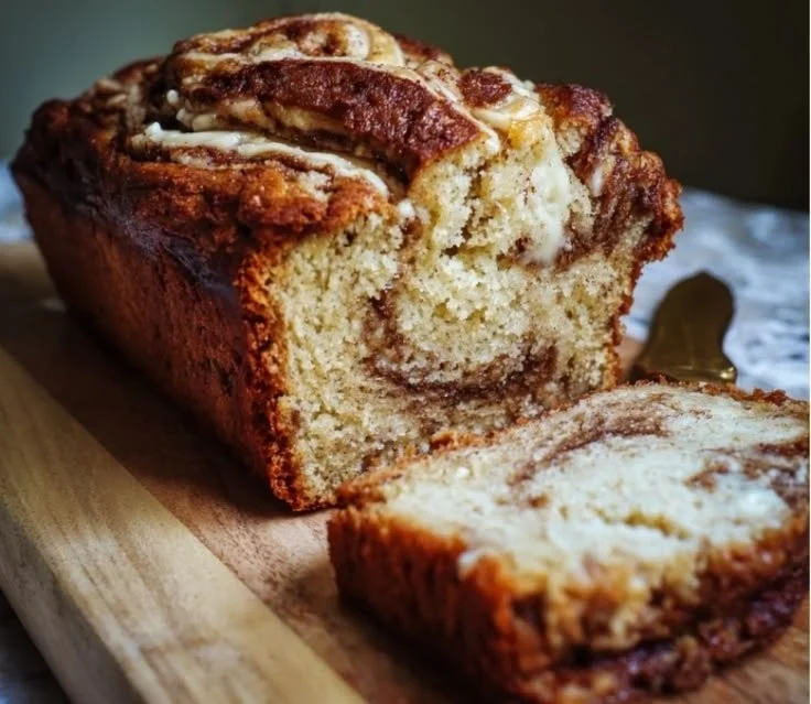 Delicious cinnamon roll banana bread with swirls and icing