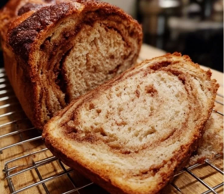 Loaf of freshly baked cinnamon sourdough bread with a golden crust