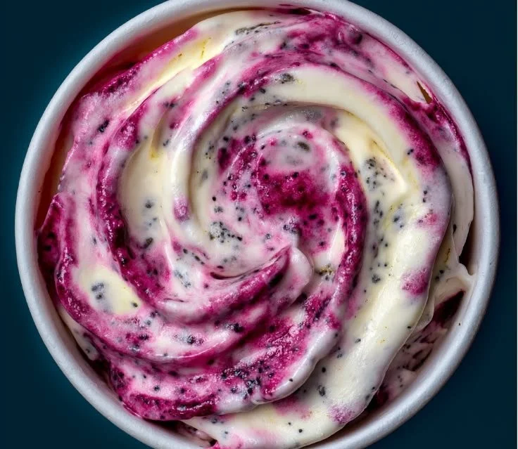 Creamy homemade frozen yogurt topped with a vibrant berry swirl